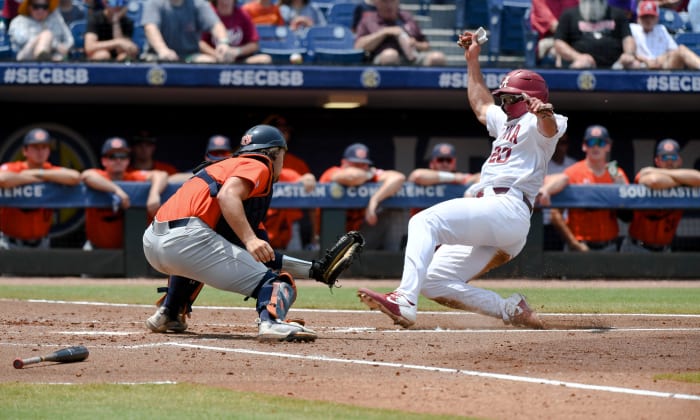Alabama base runner Tommy Seidl (20) slides safely home as Auburn catch Carter Wright was a fraction late with the tag during the SEC Tournament elimination game Thursday, May 25, 2023, at the Hoover Met. Alabama defeated Auburn 7-4 to advance.